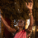 Queen Njinga with her arms raised
